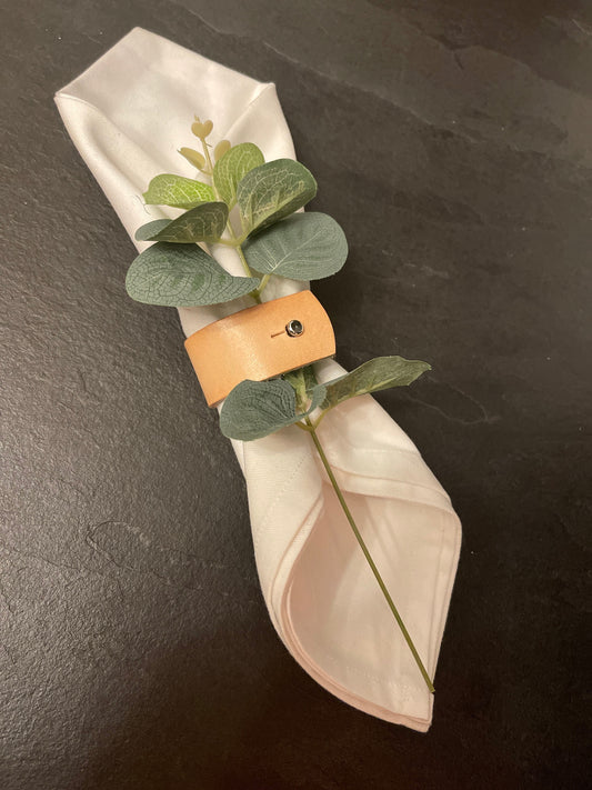 Handmade leather napkin rings on restaurant table setting