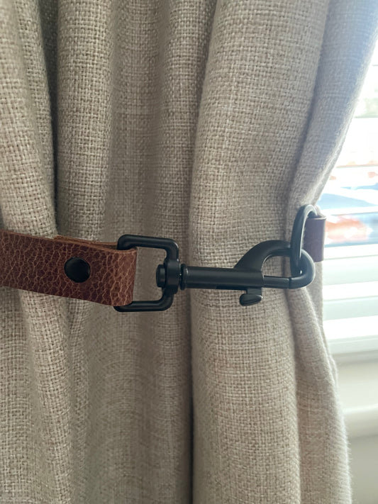Antique brown leather curtain tie back with trigger clip fixing