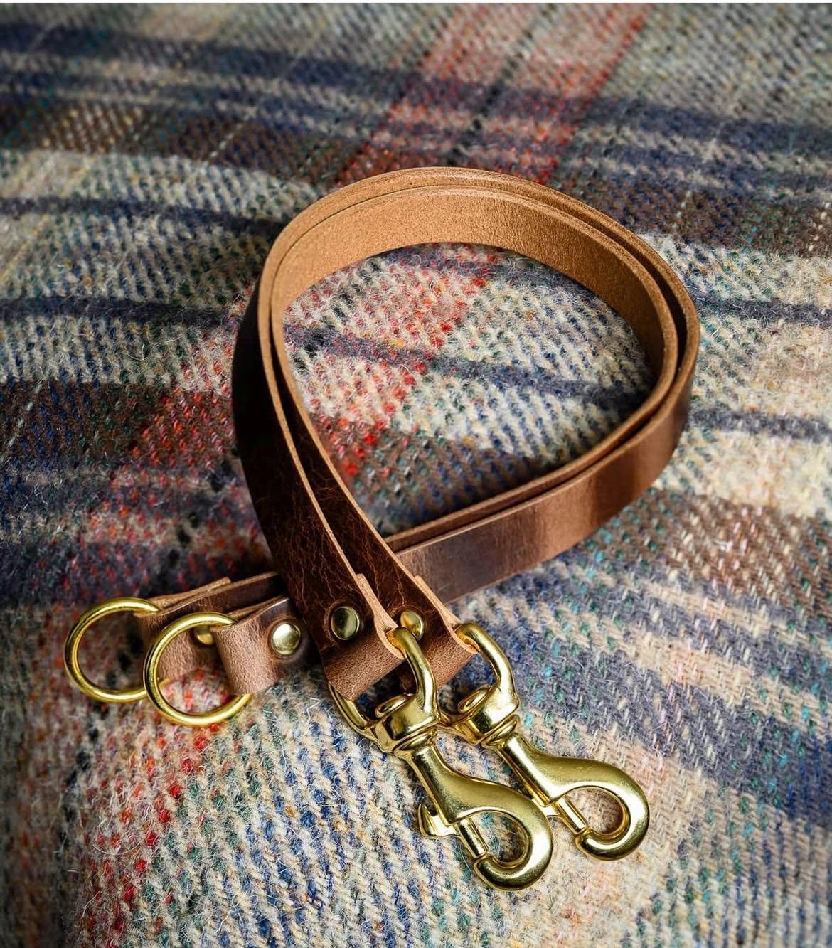 Antique brown leather curtain tie back with trigger clip fixing