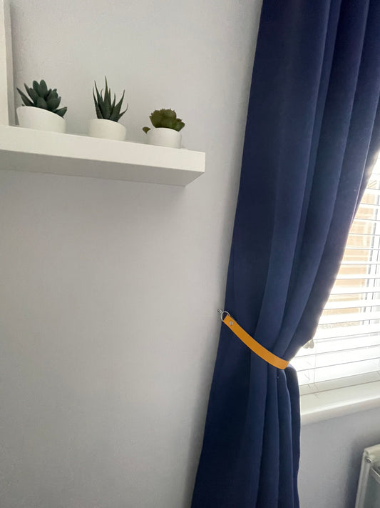 Yellow leather curtain tie back